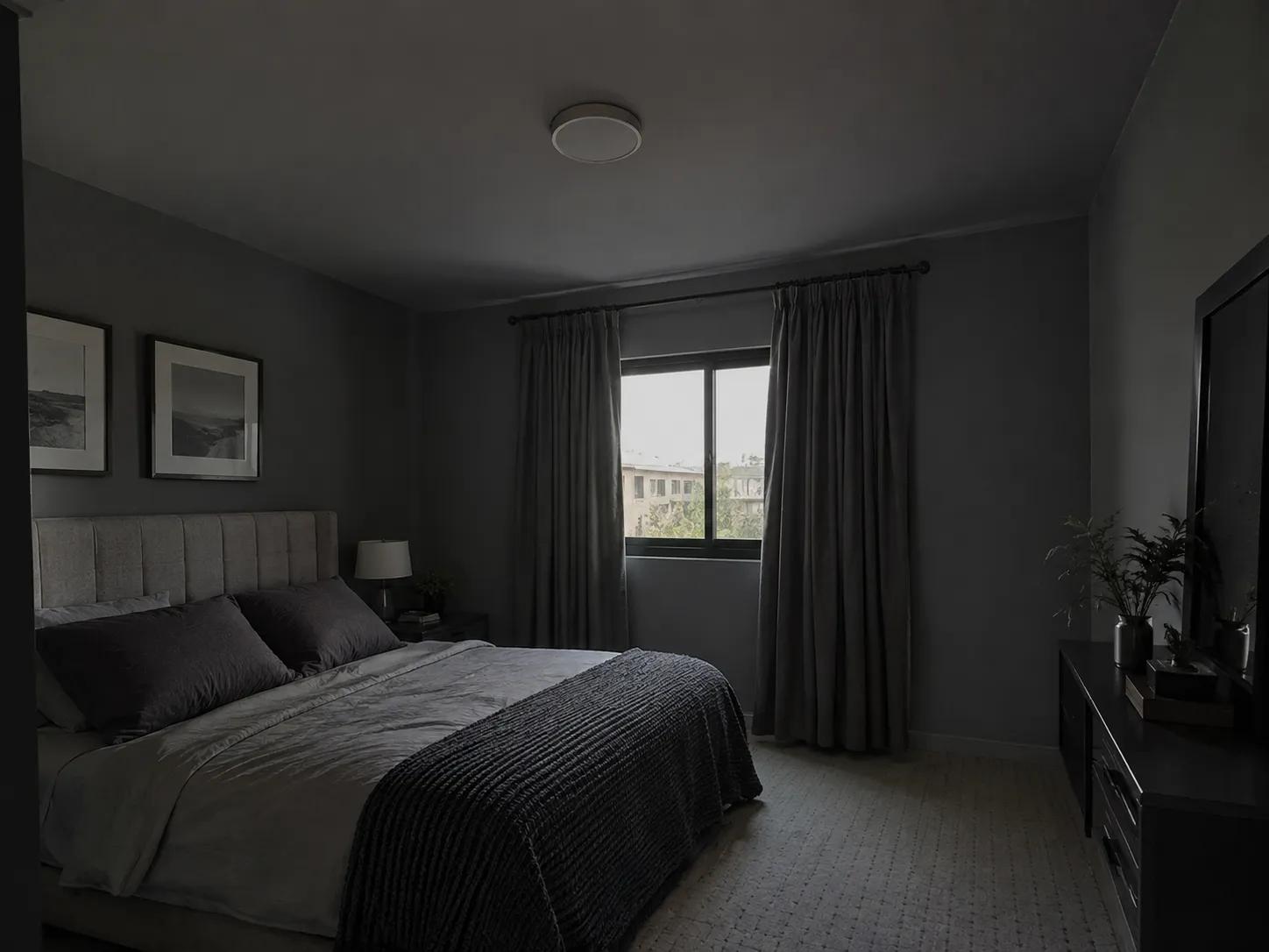 Dark gray bedroom with matching gray walls and ceiling, creating a small, gloomy feel.